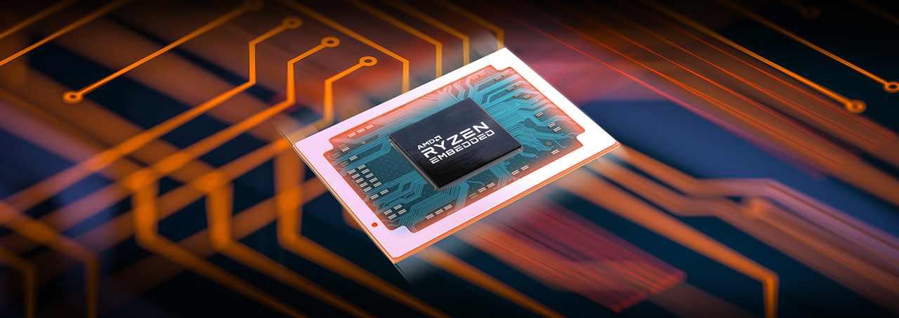 Una vista cercana de un procesador de la familia AMD Ryzen Embedded R1000 APU, El logotipo de Ryzen, con sus llamativas líneas amarillas y grises, se encuentra en la parte superior izquierda del procesador. Debajo del logotipo, el texto EMBEDDED está grabado en letras blancas.