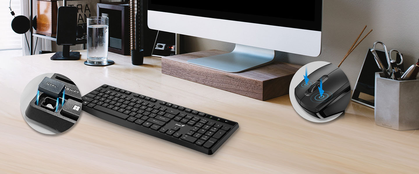 Un escritorio moderno y ordenado con un monitor de computadora iMac, un Combo de Teclado y Mouse inalámbrico Genius KM-8206S, un vaso de agua y artículos de oficina.