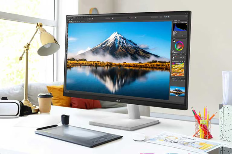 Monitor LG UltraFine™ 4K UHD IPS de 27 pulgadas 27US500-W sobre un escritorio, mostrando contenido creativo para un entorno de trabajo cómodo.