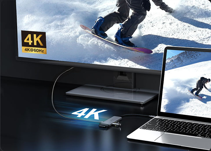 Notebook conectada a un monitor externo a través de un adaptador TP-Link, transmitiendo video en resolución 4K a 60 Hz.