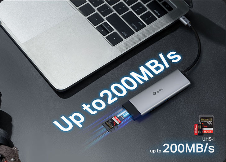 Adaptador TP-Link conectado a una notebook, leyendo una tarjeta SD SanDisk a una velocidad de hasta 200 MB/s, junto a una cámara digital.