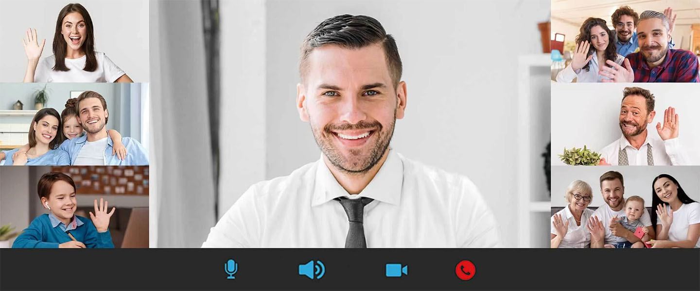 Captura de pantalla de una videollamada de múltiples participantes. En el centro, un hombre sonriendo con camisa y corbata ocupa el espacio principal. A los lados, seis ventanas más pequeñas muestran diversas personas o familias saludando, incluyendo una mujer sola, una pareja con una niña, un niño con auriculares, una pareja joven con un hombre, un hombre de mediana edad solo, y una familia de cuatro personas con un bebé. Abajo, se ven los botones de control de la videollamada (micrófono, volumen, cámara y colgar).