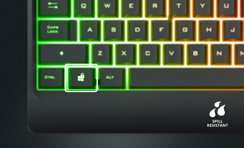 Teclado Trust Ziva con retroiluminación RGB, destacando la tecla de bloqueo de Windows en la esquina inferior izquierda. El teclado es resistente a derrames, como se indica con un icono de gotas de agua y el texto SPILL RESISTANT en la parte inferior derecha.