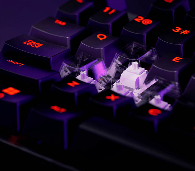 Primer plano de un Teclado Mecánico Trust GXT 871 Zora con teclas iluminadas en rojo y switches lineales visibles bajo las teclas retiradas, todo con una luz violeta intensa de fondo.