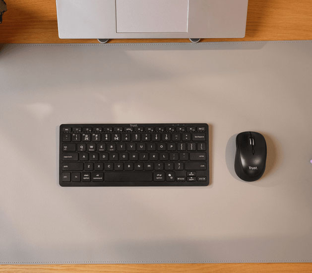 Teclado Trust Nado II Bluetooth compacto junto a un mouse Trust sobre un escritorio